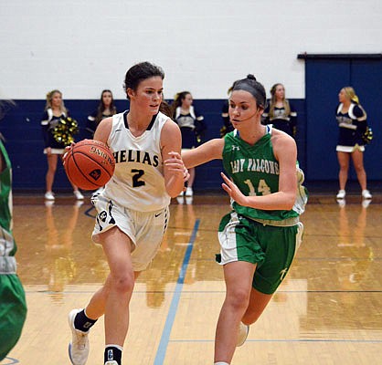 Lindsey Byers of Helias dribbles toward the basket as Mallorie Fick of Blair Oaks defends during a game last month at Rackers Fieldhouse.