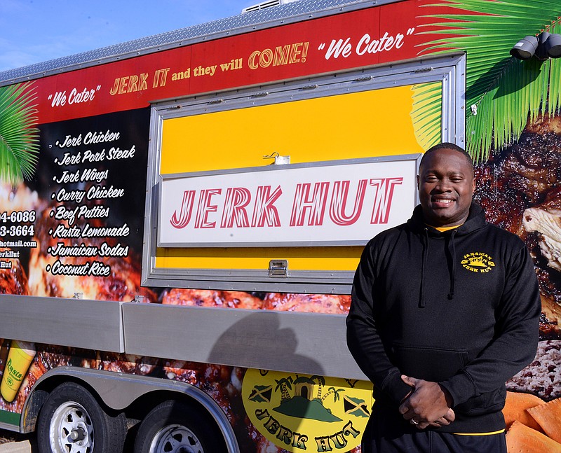 Sally Ince/ News Tribune
Co-owner Collin Russell stands in front of his Jerk Hut food truck Tuesday December 31, 2019 as it's parked outside the restuarants new physical location at 112 E. Dunklin Street. The new location is planned to open by February 1.