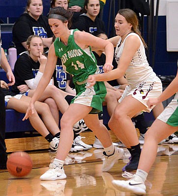 Mallorie Fick of Blair Oaks dribbles the ball past Jaida Cox of St. Joseph Benton during Friday's game at Rackers Fieldhouse.