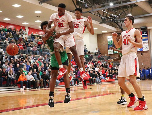 Jefferson City teammates (from left) Kaidyn Johnson and Sterling DeSha jump to avoid a Northmont player during Friday night's game at Fleming Fieldhouse.