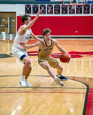 Colby LeCuru of Helias dribbles down the lane during Saturday night's semifinal game against Father Tolton in the Joe Mahens Great 8 Classic at Fleming Fieldhouse.