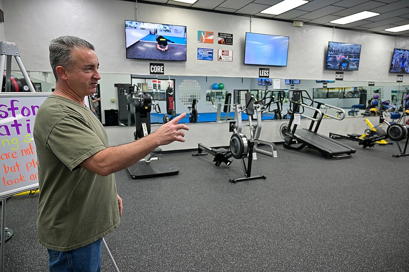 Cody Dailey, co-owner of Legends Gym and Health Club, explains the exercise equipment in one of the rooms that focuses on fitness outreach and a group support education program for beginning members at the club. Legends is a locally owned business that offers a wide variety of physical activities to keep oneself in shape and healthy.