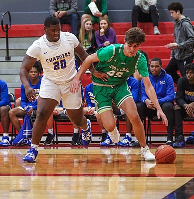 Luke Northweather of Blair Oaks tries to dribble past JJ Pegues of Oxford (Miss.) during Sunday's fifth-place game of the Joe Machens Great 8 Classic at Fleming Fieldhouse.