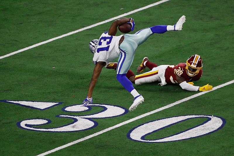 Dallas Cowboys wide receiver Michael Gallup (13) is upended and thrown off balance by Washington Redskins defensive back Jeremy Reaves (39) as he runs for a touchdown after a catch during the second half Sunday, Dec. 29, 2019, in Arlington, Texas.