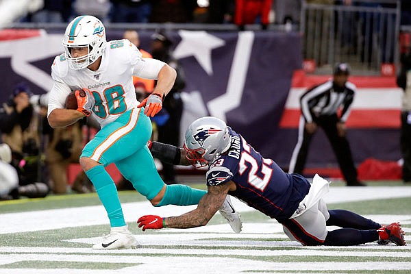 Dolphins tight end Mike Gesicki catches the winning touchdown pass in front of Patriots safety Patrick Chung in the second half of Sunday's game in Foxborough, Mass.