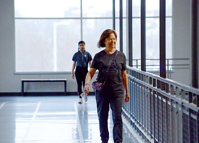 Donna Stratman walks a lap around the indoor track Thursday at The Linc.