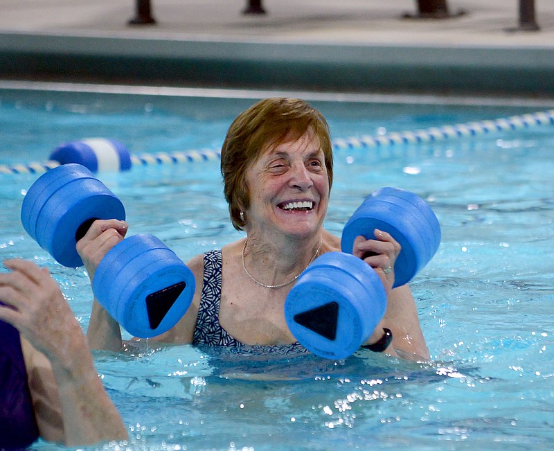 Pat Gladbach laughs with her students Friday during the water aerobics class she teaches at Knowles YMCA. Gladbach has been an instructor at the Knowles location for more than 40 years, and she teaches fitness classes three days a week.