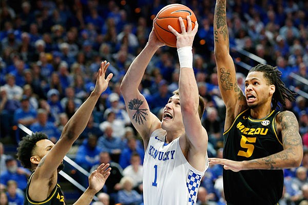 Kentucky's Nate Sestina shoots between Missouri teammates Torrence Watson (left) and Mitchell Smith during Saturday afternoon's game in Lexington, Ky.