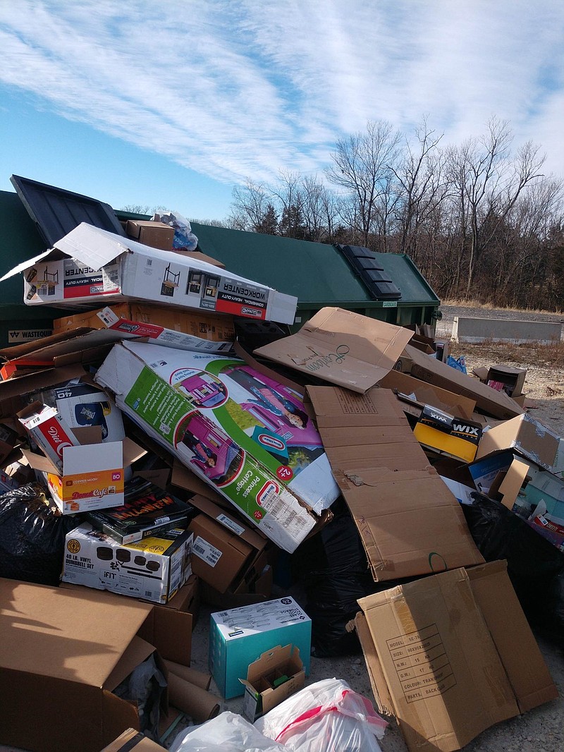 Boxes heap around city-provided recycling bins in Holts Summit. After years of misuse, the city is prepared to pull the plug on its recycling program Jan. 31.