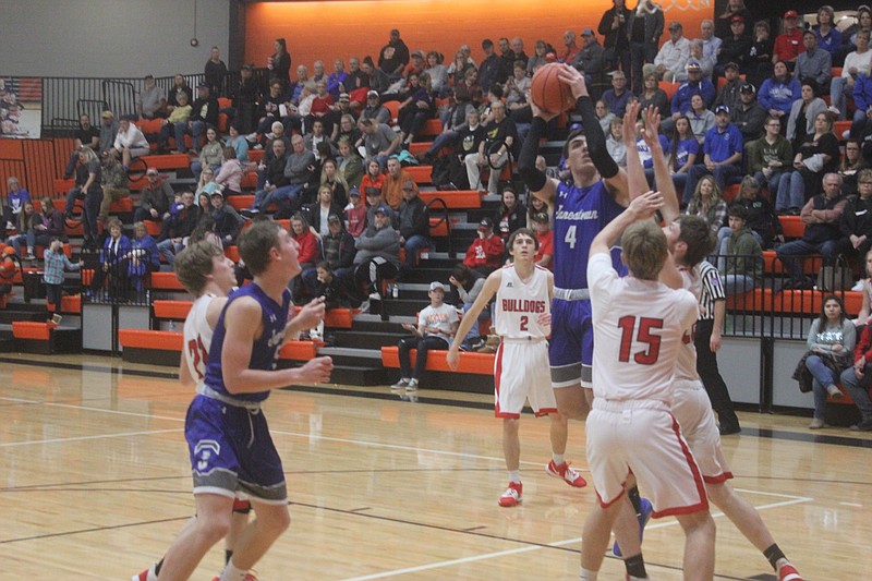 <p>Democrat photo/Kevin Labotka</p><p>Christian Snyder shoots the ball over Dixon defenders Jan. 4 during the Eagles win in the third place game at the Stover tournament.</p>