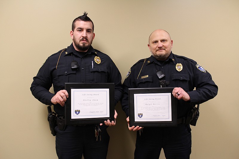 <p>Democrat photo/Austin Hornbostel</p><p>California police officers Phillip Adam, left, and Ralph Parris were honored with Life Saving Awards at the beginning of January’s City of California Board of Aldermen meeting. Adam and Parris played a part in saving lives during a drug-related arrest. Parris helped save two lives, stabilizing a fellow officer who was exhibiting side effects following exposure to drugs using Narcan spray, and also administering Narcan to a suspect who had overdosed and couldn’t breathe. Adam played a part in helping to save the officer, communicating quickly and acting fast to get extra help to the scene.</p>