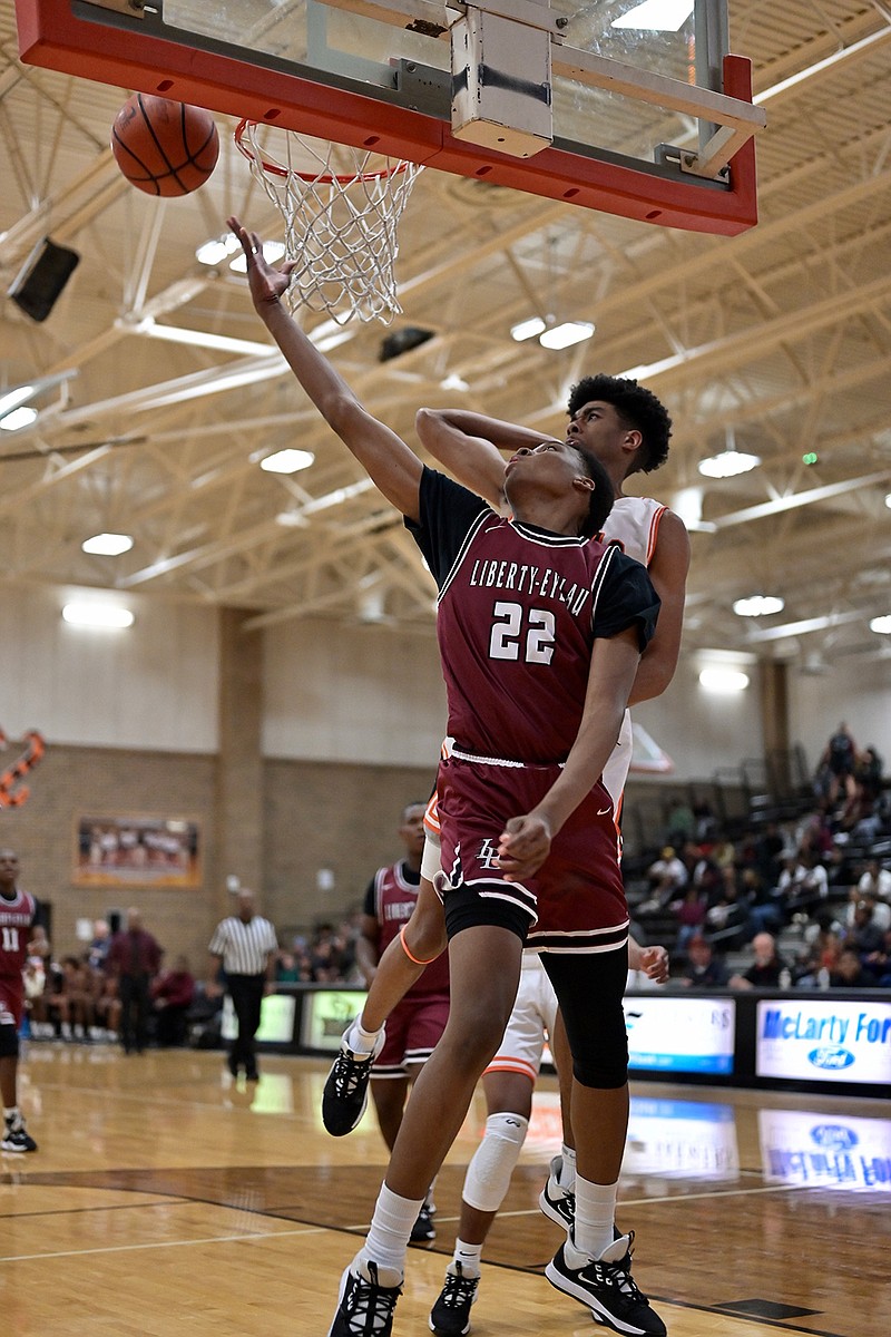 Javon Hunter of the Liberty-Eylau Leopards 
jumps up for a layup against Texas High on Tuesday at the Tiger Center.