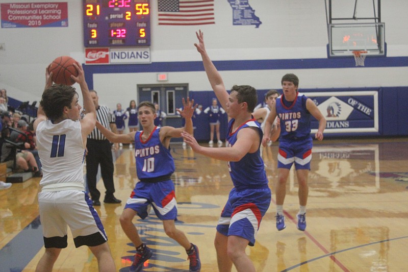 <p>Democrat photo/Kevin Labotka</p><p>California defenders guard Russellville’s Nick Graham Jan. 7 during the Pintos’ win over the Indians.</p>