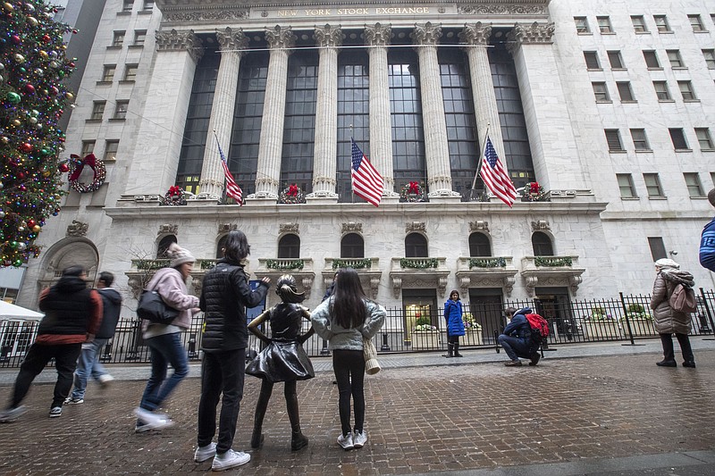 FILE - In this Jan. 3, 2020, file photo visitors to the New York Stock Exchange pause to take photos in New York. The U.S. stock market opens at 9:30 a.m. EST on Wednesday, Jan. 8. (AP Photo/Mary Altaffer, File)