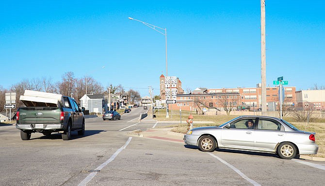 Cars drive through the intersection of Clark Avenue and Elm Street on Wednesday afternoon. Within the next five years, a roundabout may be added at the intersection, along with roundabouts at Clark Avenue and Miller Street and Clark Avenue and Dunklin Street.