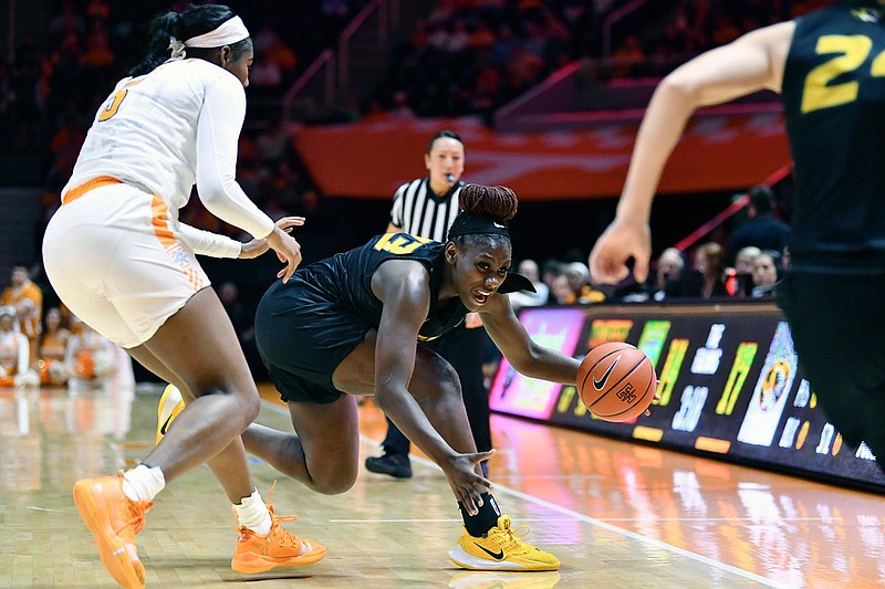 Missouri's Aijha Blackwell saves the ball from going out of bounds while being chased by Tennessee's Kamera Harris during last week's game in Knoxville, Tenn.
