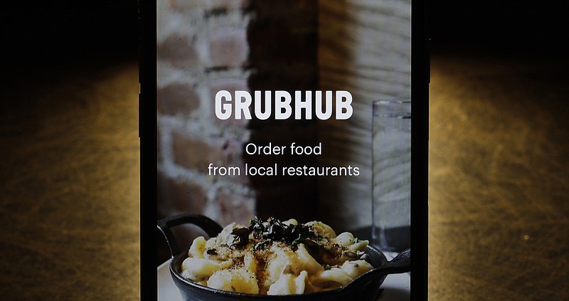 FILE - This Feb. 20, 2018, file photo shows the Grubhub app on an iPhone in Chicago. Food delivery service Grubhub is considering a possible sale of the business as competition intensifies in the sector. The Wall Street Journal reports that the company is looking at its strategic options. Grubhub competes in a sector filled with players including Uber Eats, DoorDash and Postmates. Consolidation in the industry is expected. (AP Photo/Charles Rex Arbogast, File)
