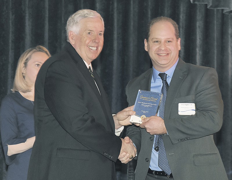 Chris Englebrecht, right, receives a Pinnacle Award from Gov. Mike Parson on Thursday as Missouri's Office of Administration hosted the annual Governor's Award for Quality and Productivity in the Capitol Rotunda. Engelbrecht, who works for MoDOT, was recognized for his work in a collaborative effort in the State Emergency Management Agency Common Operating Picture and Situational Awareness Portal. 