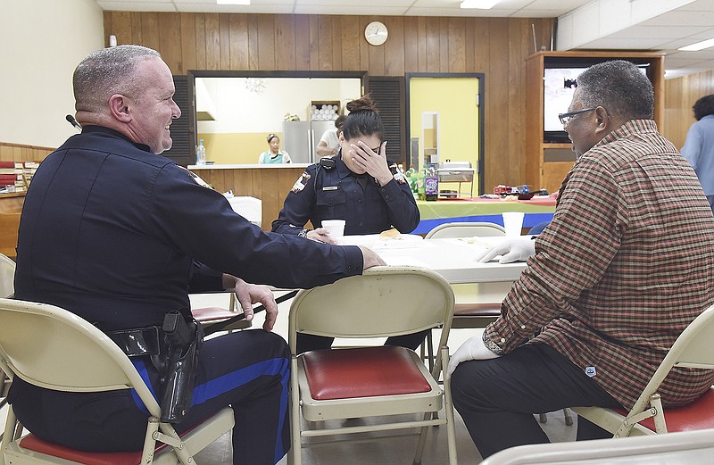 Jefferson City Police Officer Christina Greenwalt reacts Thursday to a comment from Capt. Eric Wilde, left, while the pair visits with Deacon James Washington. Second Baptist Church hosted its third First Responders Appreciation Luncheon in the church basement at 501 Monroe St. where volunteers prepared homemade chili and vegetable soup served with a choice of a ham or turkey sandwich.