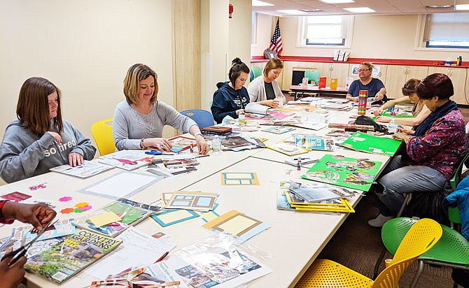 Participants in the Callaway County Public Library's class on vision boarding scour magazines for good snippets. Nature scenes, pithy quotes and pictures of Idris Elba were in particularly high demand.
