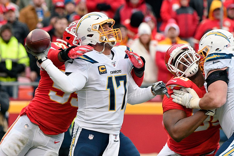 Los Angeles Chargers quarterback Philip Rivers (17) throws under pressure from Kansas City Chiefs defensive end Frank Clark (55) during the second half of an NFL football game in Kansas City, Mo., Sunday, Dec. 29, 2019. (AP Photo/Ed Zurga)