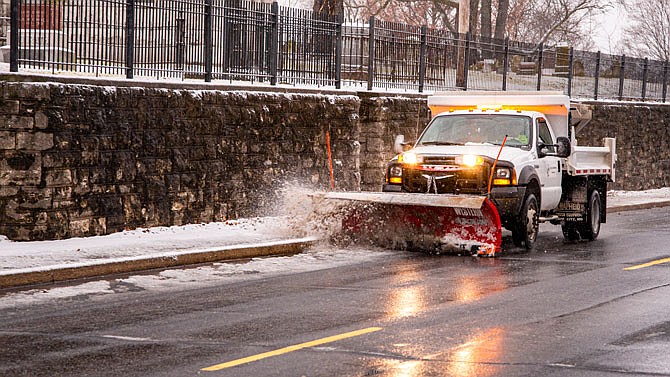 Jefferson City street crews clean McCarty Street from curb to curb Saturday.