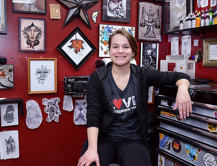 Tattoo artist Calli Loskill sits at her station Dec. 26, 2019 inside The Ink Sling Studio in Jefferson City. 