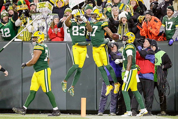 Davante Adams celebrates his touchdown catch with Packers teammate Marquez Valdes-Scantling (83) in the first half of Sunday night's game against the Seahawks in Green Bay, Wis.