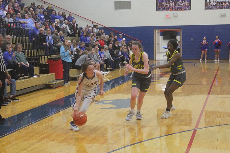 <p>Democrat photo/Kevin Labotka</p><p>Tristan Porter gets past a defender during the Pintos’ 68-32 win over Battle during the first round of the California girls tournament on Jan. 13.</p>