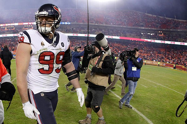 Texans defensive end J.J. Watt walks off the field after Sunday's NFL divisional playoff game against the Chiefs in Arrowhead Stadium.