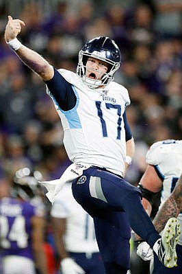 Titans quarterback Ryan Tannehill celebrates after scoring a touchdown during Saturday night's game against the Ravens in Baltimore.