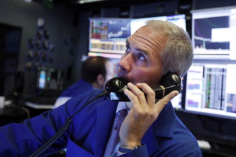 FILE - In this Jan. 9, 2020, file photo trader Timothy Nick works in his booth on the floor of the New York Stock Exchange. The U.S. stock market opens at 9:30 a.m. EST on Tuesday, Jan. 14.  (AP Photo/Richard Drew, File)