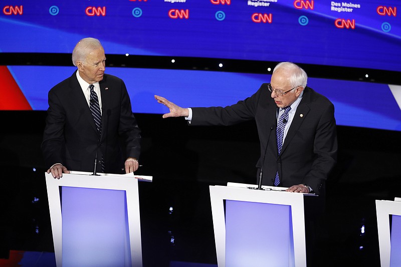 Democratic presidential candidate former Vice President Joe Biden, left, watches as Sen. Bernie Sanders, I-Vt., answers a question Tuesday, Jan. 14, 2020, during a Democratic presidential primary debate hosted by CNN and the Des Moines Register in Des Moines, Iowa. (AP Photo/Patrick Semansky)