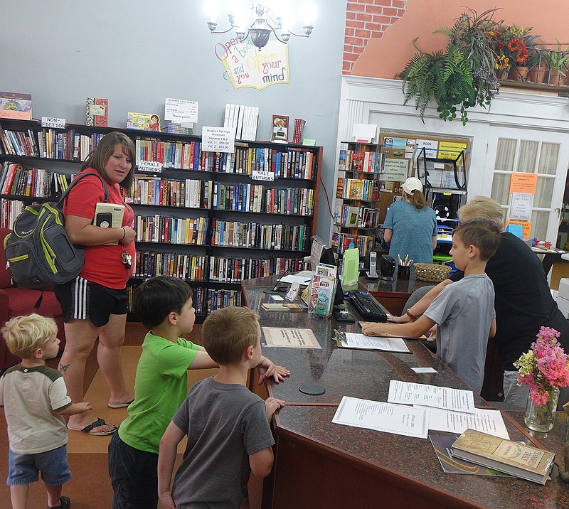 The Hughes Springs public comes into a lively and colorful library when walking in the front door. Brittany Jones is shown bringing children for a "Libraries' Rock" program.
