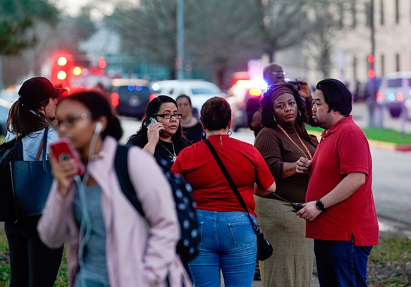 People wait outside Bellaire High School after a shooting, Tuesday, Jan. 14, 2020, in Bellaire, Texas. (Melissa Phillip/Houston Chronicle via AP)