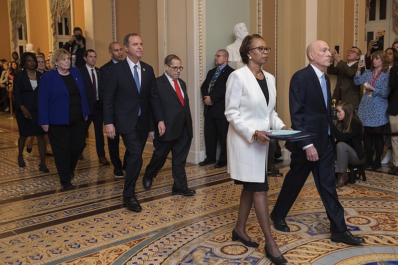 House Sergeant at Arms Paul Irving and Clerk of the House Cheryl Johnson carry the articles of impeachment against President Donald Trump to Secretary of the Senate Julie Adams on Capitol Hill in Washington, Wednesday, Jan. 15, 2020. Following are impeachment managers, House Judiciary Committee Chairman, Rep. Jerrold Nadler, D-N.Y., House Intelligence Committee Chairman Adam Schiff, D-Calif., Rep. Hakeem Jeffries, D-N.Y., Rep. Sylvia Garcia, D-Texas, Rep. Val Demings, D-Fla., Rep. Zoe Lofgren, D-Calif., and Rep. Jason Crow, D-Colo. (AP Photo/Manuel Balce Ceneta) , Wednesday, Jan. 15, 2020. (AP Photo/Manuel Balce Ceneta)