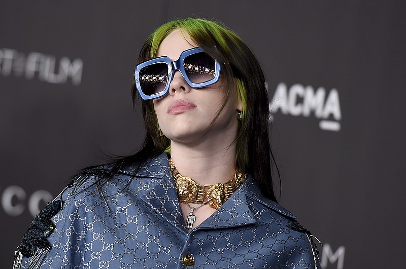 This Nov. 2, 2019 file photo shows singer Billie Eilish at the 2019 LACMA Art and Film Gala in Los Angeles. Eilish is set to the sing the theme song for the upcoming James Bond film, becoming the youngest act to write and record a song for the iconic film franchise. Eilish, who turned 18 in December, recorded the song for the 25th Bond film, "No Time to Die," which debuts in U.S. theaters on April 10. (Photo by Jordan Strauss/Invision/AP, File)