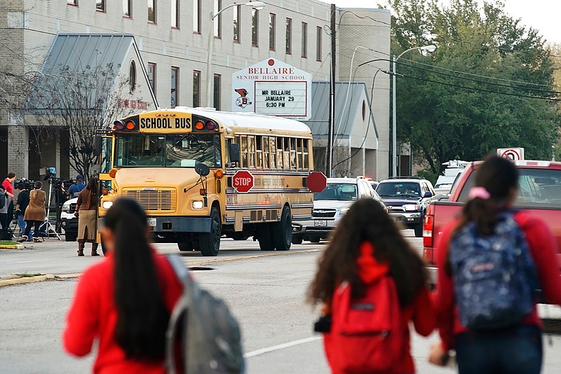 Students watch from across the street as authorities respond to a shooting at Bellaire High School in Bellaire, Texas, Tuesday, Jan. 14, 2020. (Mark Mulligan/Houston Chronicle via AP)