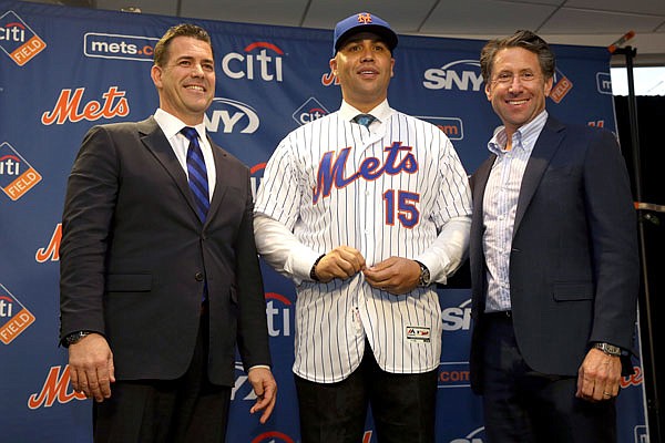 In this Nov. 4, 2019, file photo, Carlos Beltran (center) poses for a picture with general manager Brodie Van Wagenen (left) and Mets COO Jeff Wilpon during a news conference announcing him as Mets manager in New York.