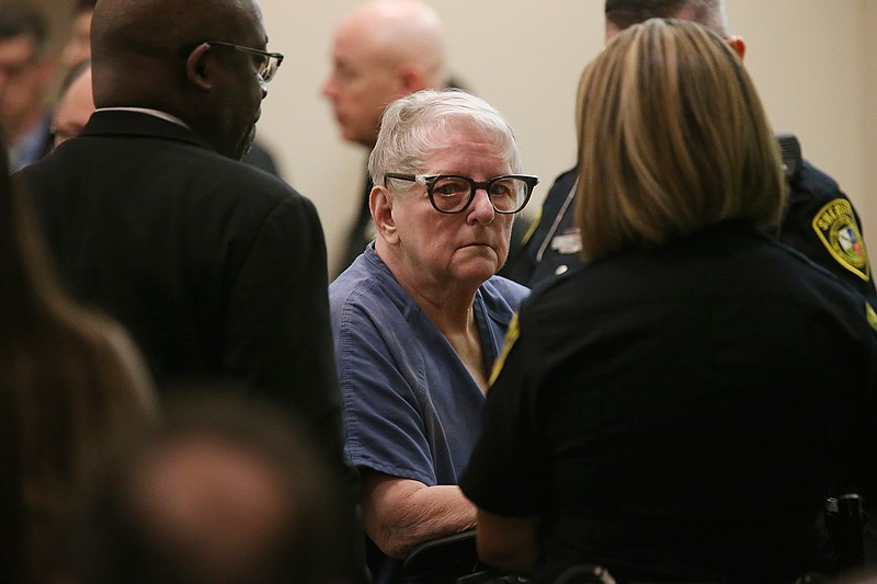 Convicted child killer Genene Jones is escorted out of the Bexar County 399th State District Court in San Antonio, Thursday, Jan. 16, 2020. The former Texas nurse suspected in the killing of dozens of children pleaded guilty in the 1981 death of an 11-month-old boy, receiving a life sentence that a prosecutor said should ensure she dies in prison. (Jerry Lara/The San Antonio Express-News via AP)