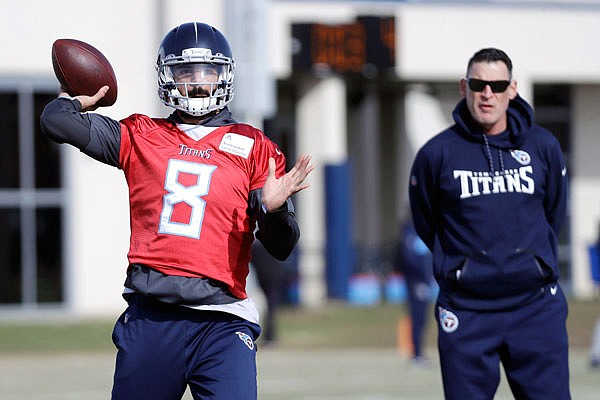 Titans quarterback Marcus Mariota throws as quarterbacks coach Pat O'Hara watches during practice Thursday in Nashville, Tenn.