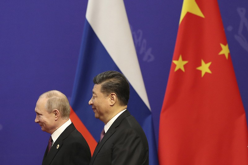 FILE - In this April 26, 2019 file photo, Russian President Vladimir Putin, left, and Chinese President Xi Jinping, right, attend an event at the Friendship Palace in Beijing. Putin and Xi have established themselves as the world’s most powerful authoritarian leaders in decades. Now it looks like they want to hang on to those roles indefinitely. Putin's sudden announcement of constitutional changes that could allow him to extend control way beyond the end of his term in 2024 echoes Xi’s move in 2018 to eliminate constitutional term limits on the head of state. (Kenzaburo Fukuhara/Pool Photo via AP, File)