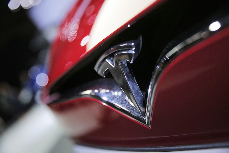 FILE- This Sept. 30, 2016, file photo shows the logo of the Tesla model S at the Paris Auto Show in Paris, France.  The U.S. government's auto safety agency is looking into allegations that all three of Tesla's electric vehicles can suddenly accelerate on their own. An unidentified person petitioned the National Highway Traffic Safety Administration asking for an investigation into the problem. The agency says the allegations include about 500,000 Tesla Model 3, Model S and Model X vehicles from the 2013 through 2019 model years. (AP Photo/Christophe Ena, File)