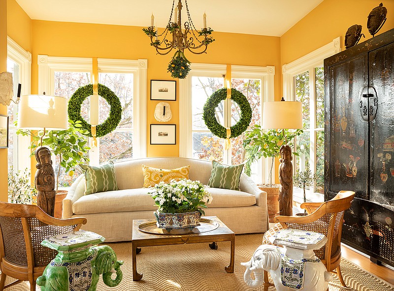 This photo shows a room design by Josh Hildreth. This Washington, D.C., sunroom feels bright even on winter afternoons, thanks to windows that don't have any draperies, a light-colored rug and citrus trees that add a fresh, bright scent to the space. (Photo by Gordon Beall/Josh Hildreth via AP)