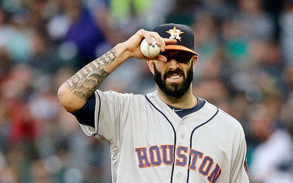 Mike Fiers adjusts his cap during an Astros game against the Mariners during the 2016 season in Seattle.