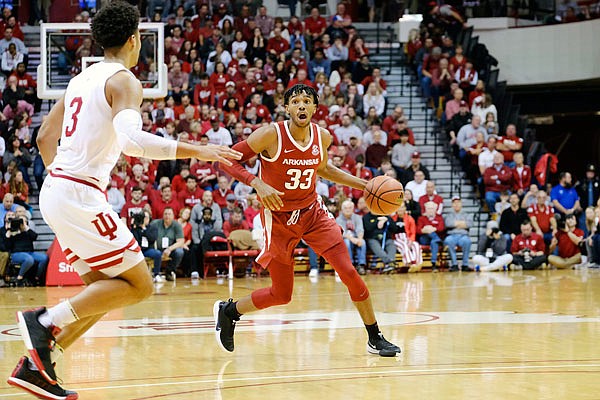 Jimmy Whitt Jr. of Arkansas brings the ball upcourt in front of Indiana's Justin Smith during a game last month in Bloomington, Ind.