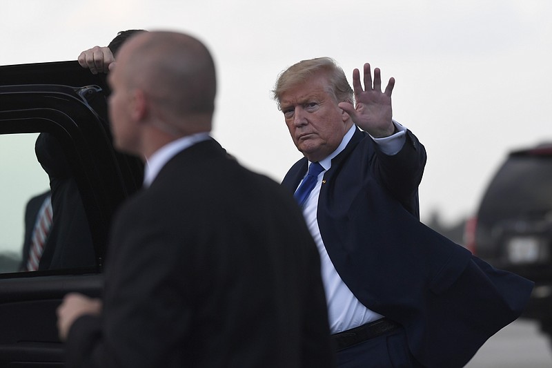 President Donald Trump waves before getting into his vehicle after arriving at Palm Beach International Airport in West Palm Beach, Fla., Friday, Jan. 17, 2020. Trump and his family are spending the weekend at their Mar-a-Lago estate. (AP Photo/Susan Walsh)