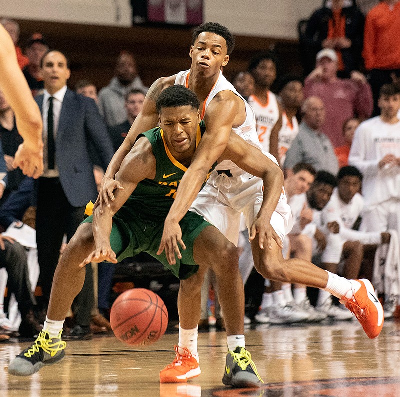 Oklahoma State guard Avery Anderson III, rear, fouls Baylor guard Jared Butler (12) in the final minutes of an NCAA college basketball game in Stillwater, Okla., Saturday, Jan. 18, 2020. (AP Photo/Brody Schmidt)