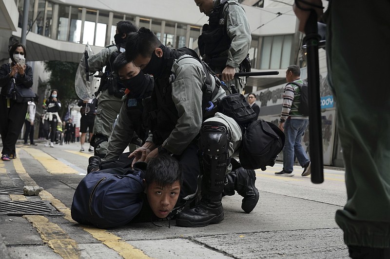 Riot police detain protesters calling for electoral reforms and a boycott of the Chinese Communist Party in Hong Kong, Sunday, Jan. 19, 2020. Hong Kong has been wracked by often violent anti-government protests since June, although they have diminished considerably in scale following a landslide win by opposition candidates in races for district councilors late last year. (AP Photo/Kin Cheung)