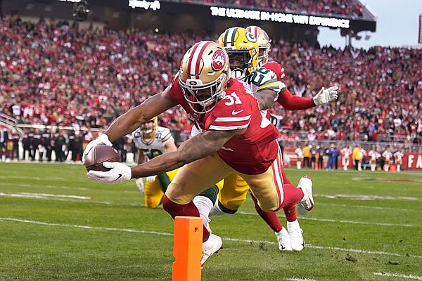 49ers running back Raheem Mostert scores in front of Packers free safety Darnell Savage during the first half of the NFC Championship Game on Sunday in Santa Clara, Calif.